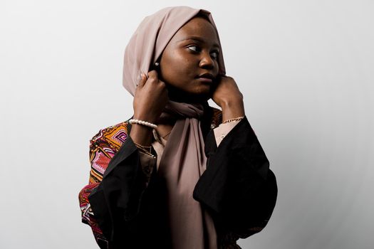 Dreamy black girl weared hijab smile and rejoise on white background. Muslim happy woman posing in studio. Attractive african female.