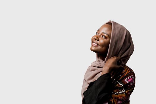 Dreamy black girl weared hijab smile and rejoise on white background. Muslim happy woman posing in studio. Attractive african female.