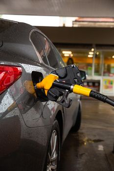 Filling Car With gasoline At Petrol Station Car refueling fuel on petrol station. Service is filling gas or biodiesel into the tank.