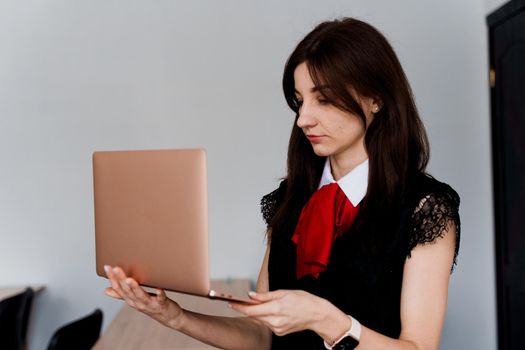 Teacher with laptop on white background. . Foreign school private study with a school girl. Teacher explain grammar of native language using laptop.