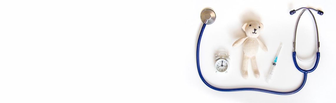 Teddy bear stethoscope and syringe isolate on a white background. Selective focus.