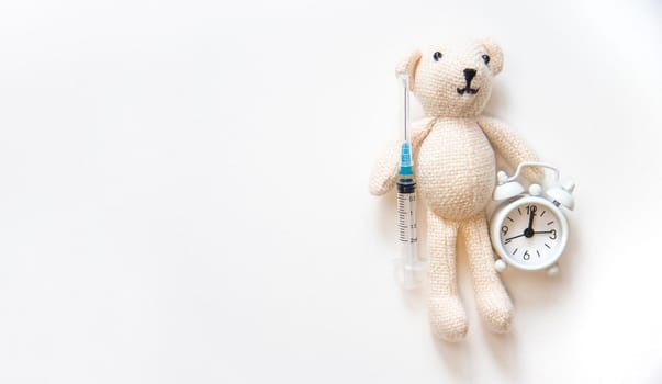 Teddy bear stethoscope and syringe isolate on a white background. Selective focus.