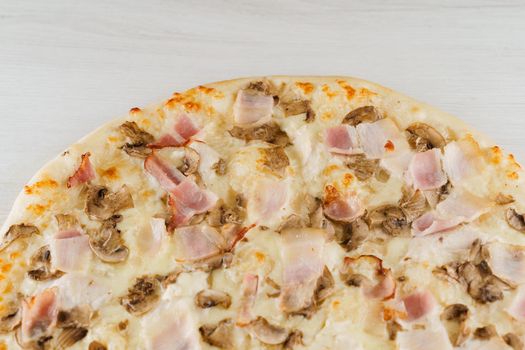 Pizza with bacon, mushrooms and cheese isolated on white wooden background. Advert for social network of restaurants, caffee. Promotion for pizzeria