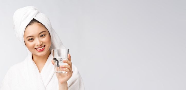 Healthy young beautiful woman drinking water, beauty face natural makeup, isolated over white background