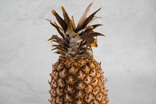 Pineapple tropical fruit on white stone background background. Citrus fruit with vitamin c for helth care