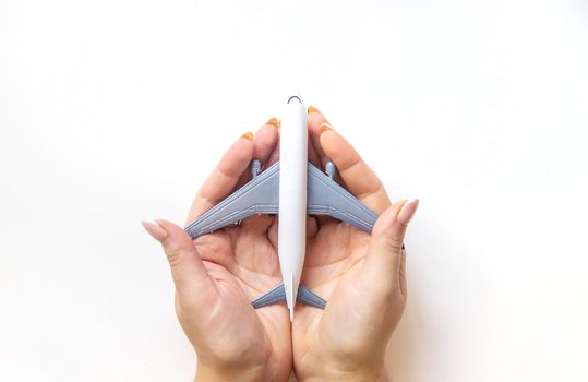 Airplane in hands on a white background. Selective focus.