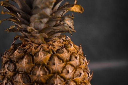 Pineapple tropical fruit on dark stone background background. Citrus fruit with vitamin c for helth care