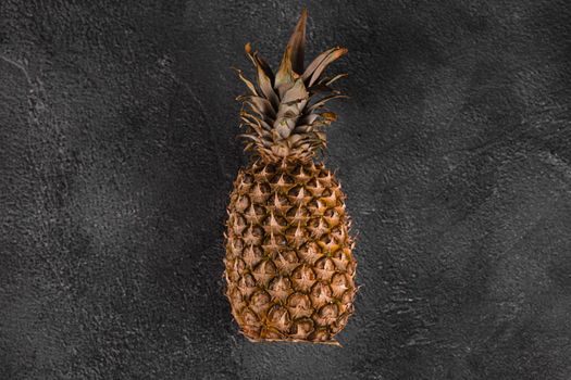 Pineapple tropical fruit on dark stone background background. Citrus fruit with vitamin c for helth care