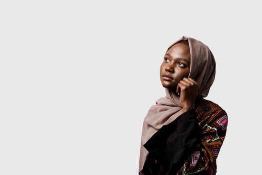 Dreamy black girl weared hijab smile and rejoise on white background. Muslim happy woman posing in studio. Attractive african female.