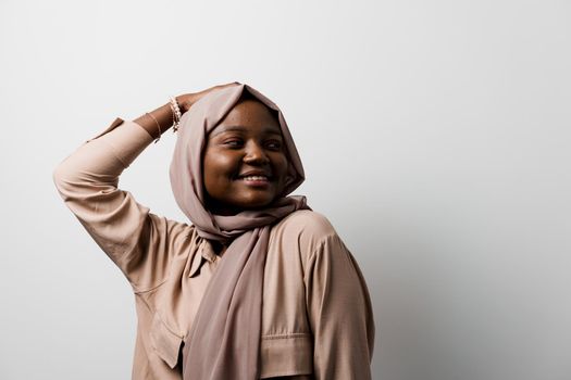 Happy and funny black girl on white background. Young muslim woman smiling in studio. Advert for social network.