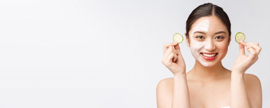 Beauty young asian women skin care image with cucumber on white background studio.