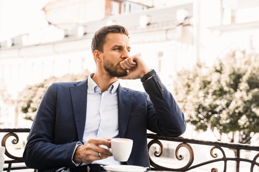 Handsome man with cup of coffee in cafe. Morning lifestyle of male
