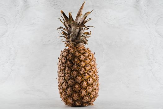 Pineapple tropical fruit on white stone background background. Citrus fruit with vitamin c for helth care