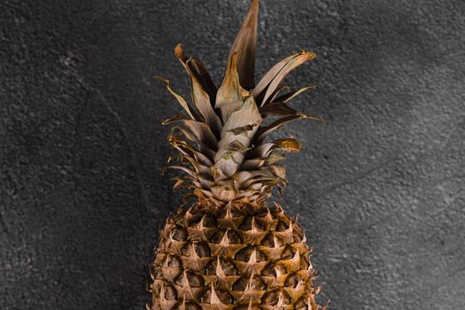 Pineapple tropical fruit on dark stone background background. Citrus fruit with vitamin c for helth care