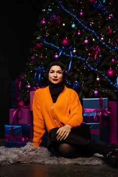 Muslim Christmas celebration. Model weared black hijab is prepearing for new year celebration. Islam religion