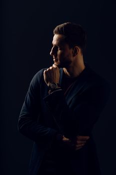 Business man portrait on dark background. Handsome young man weared suit in studio. Confident professional fashion male posing in studio.