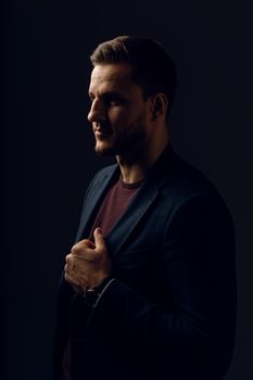 Business man portrait on dark background. Handsome young man weared suit in studio. Confident professional fashion male posing in studio.