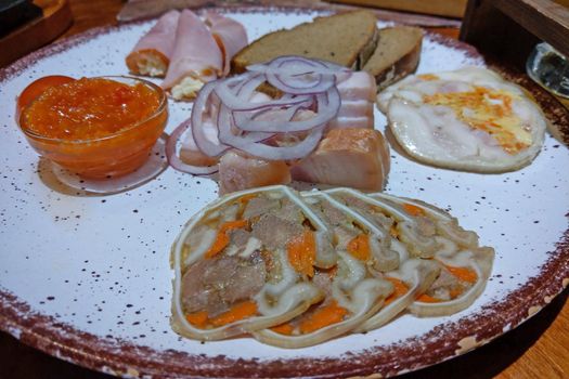 Cold cuts of meat on a plate with sauces