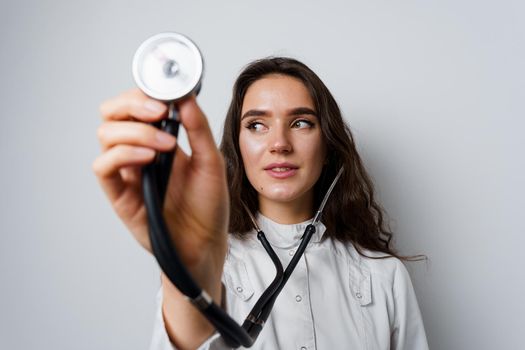 Medical student girl doing auscultation to patient. Doctor uses phonendoscope for auscultation. Medical therapy and treatment