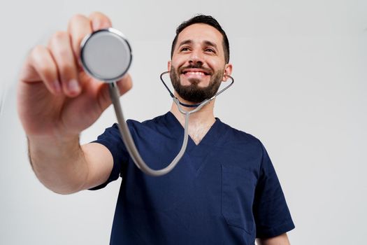 Smiley arabian doctor surgeon with stethoscope on white background. Professional arab medecine. advert for medical clinic