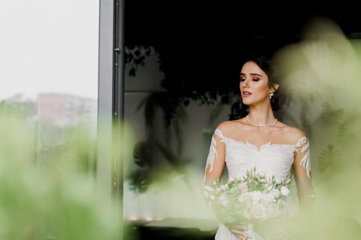 Bride in wedding dress and bridal veil in cafe. Advert for social networks for wedding agency and bridal salon