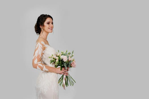 Bride in white wedding dress with bouquet in studio on white blank background right side. Advert for social networks for wedding agency and bridal salon