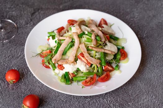 Caesar salad with chicken and parmesan, cherry tomato, lettuce, croutons and egg,