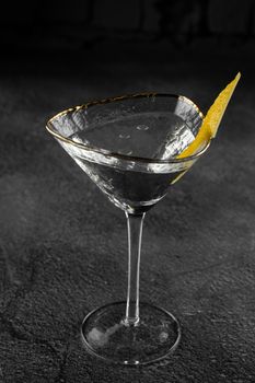 Glass margarita alcohol coctail drink with citrus on a gray background. Chalet