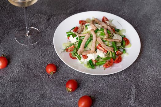 Caesar salad with chicken and parmesan, cherry tomato, lettuce, croutons and egg.