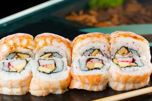 Rolls with shrimp, cheese, and eel, avocado and caviar, nori close-up