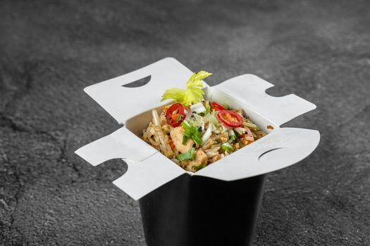 Rice in wok box for food delivery. Asian spicy dish for street restaurant and fast food cafe.