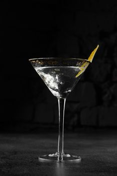 Glass margarita alcohol coctail drink with citrus on a gray background. Chalet