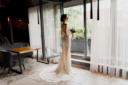 Bride in wedding dress and bridal veil in cafe. Advert for social networks for wedding agency and bridal salon