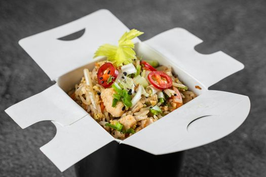 Rice in wok box for food delivery. Asian spicy dish for street restaurant and fast food cafe.