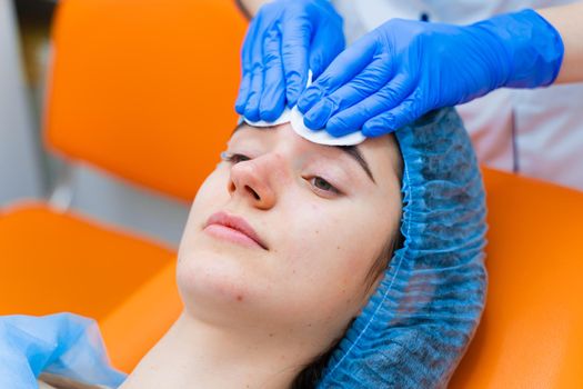 Spa procedure. Facial massage and spreading cream. Cosmetic skin care