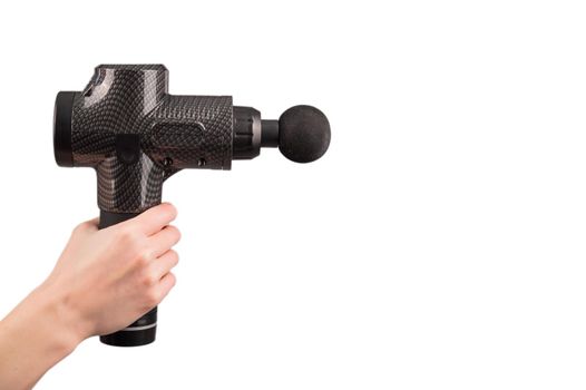 Close-up of a female hand with a portable massager gun on a white background