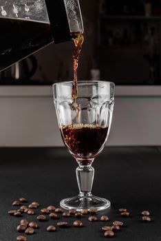 Alternative method of making coffee. coffeemaker is a manual pour-over style glass. Cofee brewing on black background