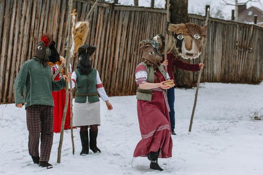 People in national costumes with animal heads celebrate the arrival of the pagan holiday Maslenitsa.