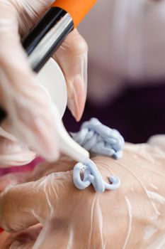 Facial blue gel mask on the brush. Prepearing for cosmetological peeling procedure