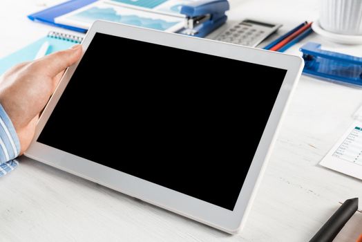 close-up of men's hands with a computer tablet. Businessman works in the office