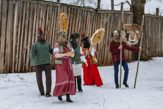 People in national costumes with animal heads celebrate the arrival of the pagan holiday Maslenitsa.