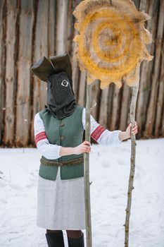 A man in a national costume with the head of an animal celebrates the arrival of the pagan holiday Maslenitsa.