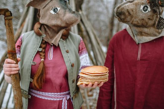 People in national costumes with animal heads celebrate the arrival of the pagan holiday Maslenitsa.