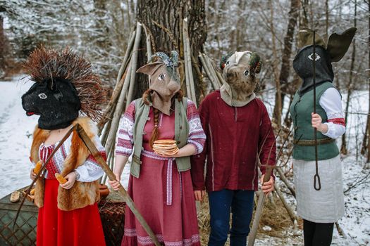 People in national costumes with animal heads celebrate the arrival of the pagan holiday Maslenitsa.