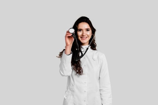 Doctor in medical robe with stethoscope at coronavirus covid-19 period. Nurse in white medical dress on white background