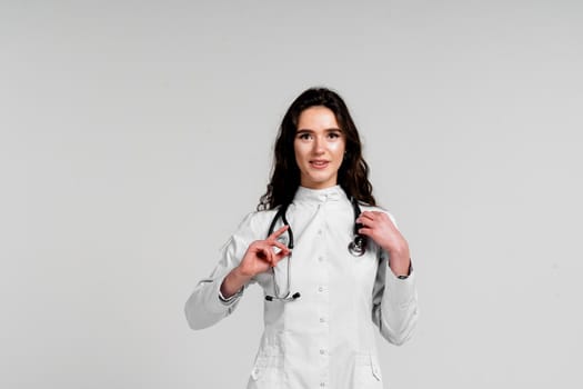 Doctor in medical robe with stethoscope at coronavirus covid-19 period. Nurse in white medical dress on white background