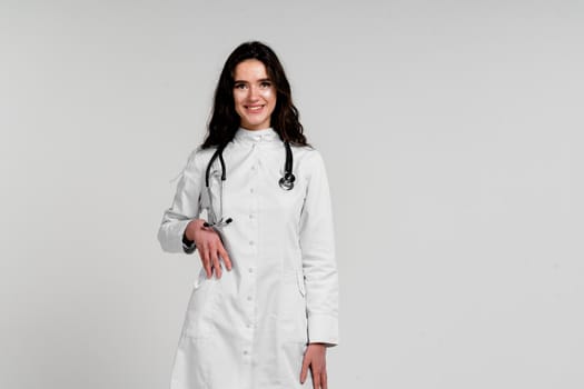 Doctor in medical robe with stethoscope at coronavirus covid-19 period. Nurse in white medical dress on white background