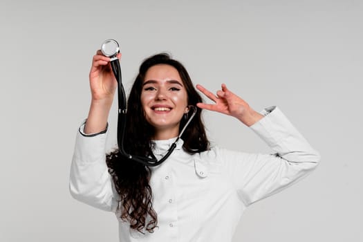 Doctor in medical robe with stethoscope at coronavirus covid-19 period. Nurse in white medical dress on white background