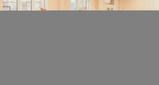 Group of young womans fitness instructor in Sportswear Leggings and Tops, stretching in the gym before pilates, on a yoga mat near the large window on a sunny day, female fitness yoga routine concept.