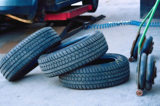 Replacing a car wheel at a tire station. a rubber covering, typically inflated or surrounding an inflated inner tube, placed around a wheel to form a flexible contact with the road.